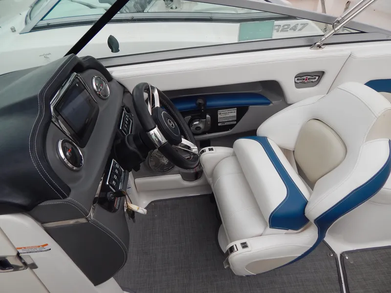 Slide: The Image of 2016 Chaparral 246 SSi boat interior with steering wheel and white-blue seating. - 24