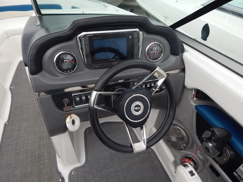 Slide: The Image of 2016 Chaparral 246 SSi boat dashboard with steering wheel and control panel. - 26