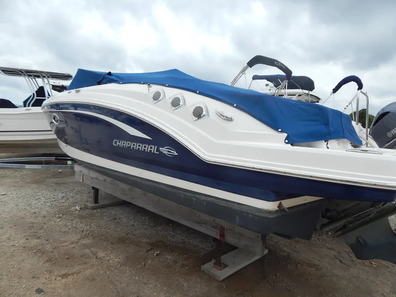Slide: The Image of 2016 Chaparral 246 SSi boat with blue cover on dry dock. - 3