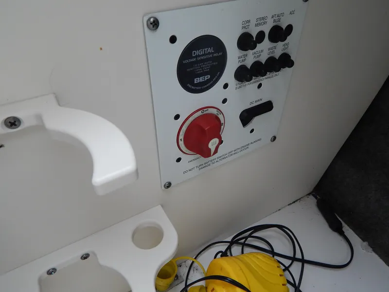 Slide: The Image of Control panel of a 2016 Chaparral 246 SSi boat with switches and wiring. - 31