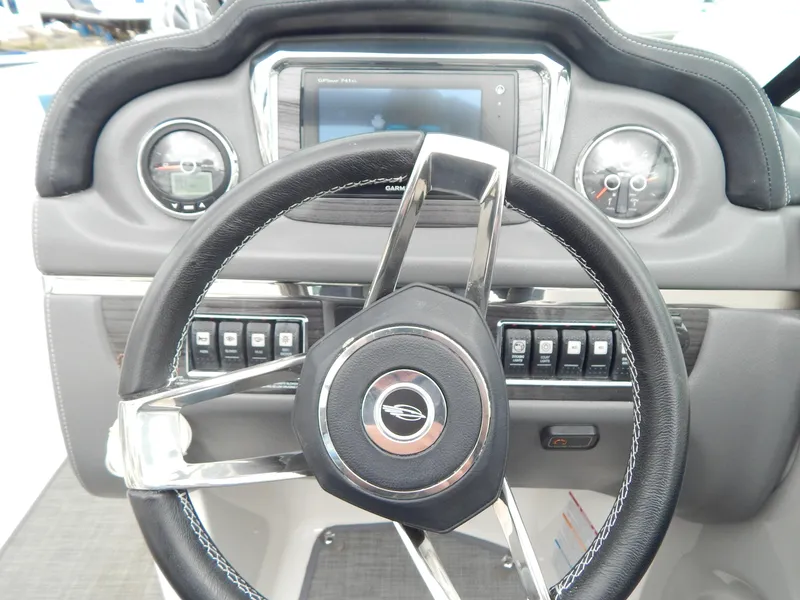 Slide: The Image of Steering wheel and dashboard of 2016 Chaparral 246 SSi boat. - 34