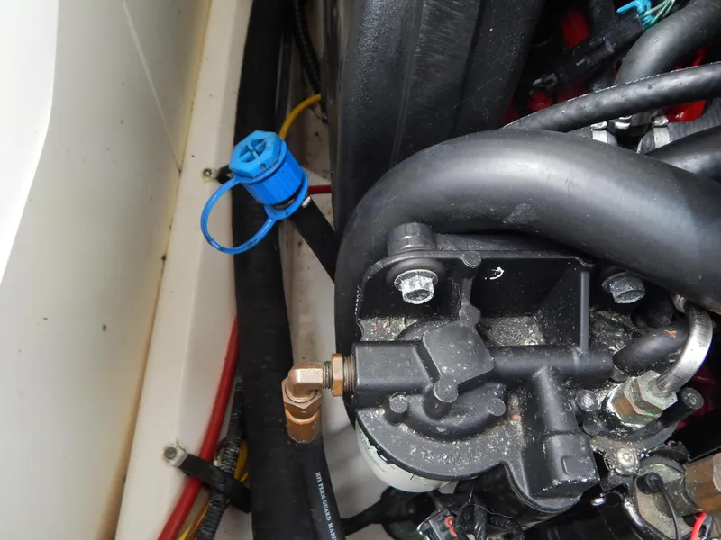 Slide: The Image of Engine compartment of 2016 Chaparral 246 SSi boat, showing hoses and components. - 40