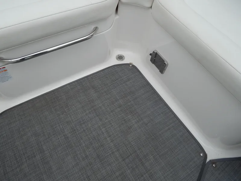 Slide: The Image of Interior of 2016 Chaparral 246 SSi boat with gray carpet and white seating. - 42