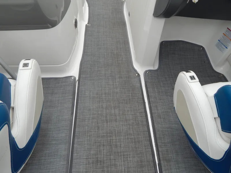 Slide: The Image of 2016 Chaparral 246 SSi boat interior with gray flooring and white-blue seating. - 43