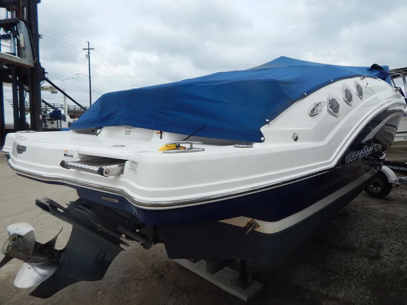 Slide: The Image of 2016 Chaparral 246 SSi boat with blue cover, docked on a trailer. - 6