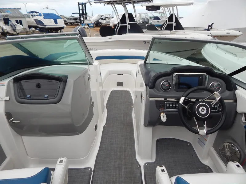 Slide: The Image of 2016 Chaparral 246 SSi boat interior with steering wheel and dashboard controls. - 8