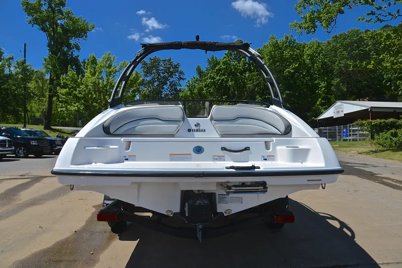 Slide: The Image of 2023 Yamaha Boats AR190, rear view, parked outdoors on a sunny day. - 13