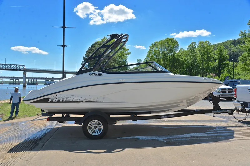Slide: The Image of 2023 Yamaha Boats AR190 on trailer by river, sunny day, blue sky, green trees. - 15