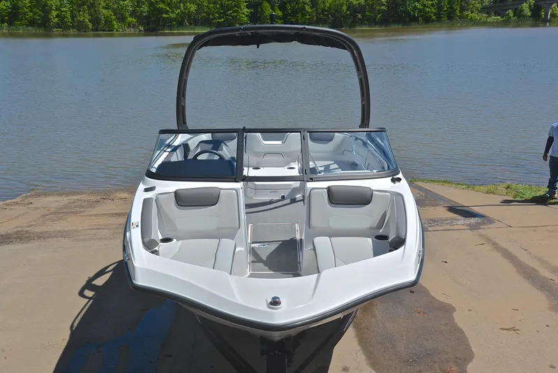 Slide: The Image of 2023 Yamaha AR190 boat on a ramp by a lake, showcasing sleek design and seating. - 17