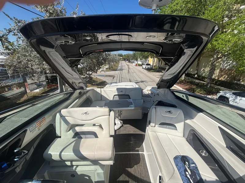 Slide: The Image of 2014 Monterey 328 Super Sport boat interior with open canopy and seating. - 13