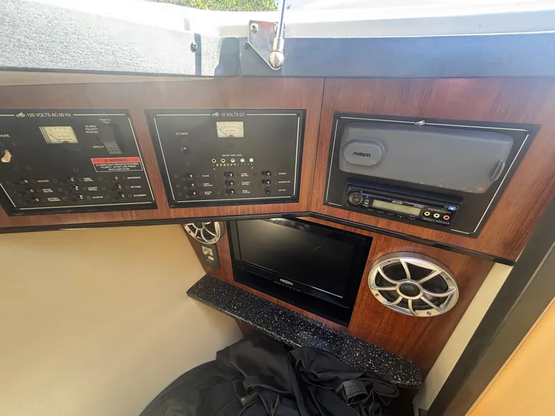 Slide: The Image of Control panel and audio system in 2014 Monterey 328 Super Sport boat interior. - 17