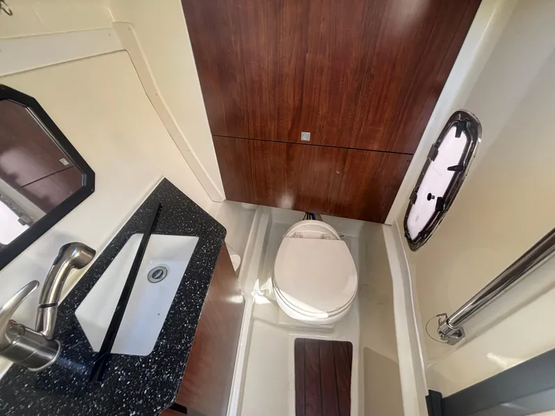 Slide: The Image of 2014 Monterey 328 Super Sport boat bathroom with sink, toilet, and wood accents. - 19