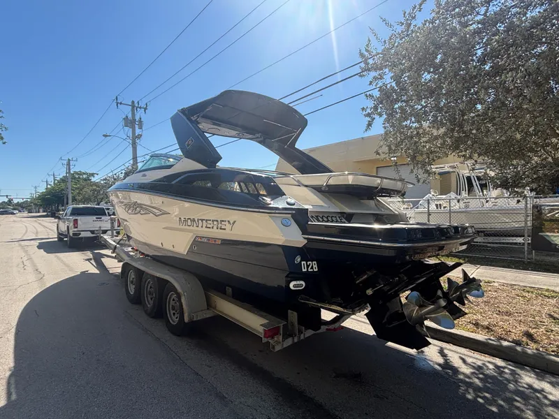 Slide: The Image of 2014 Monterey 328 Super Sport boat on trailer, parked on a sunny street. - 3