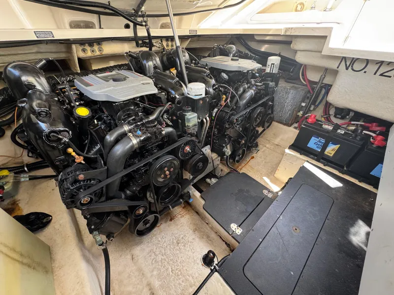 Slide: The Image of Engine compartment of a 2014 Monterey 328 Super Sport boat, featuring dual engines. - 9