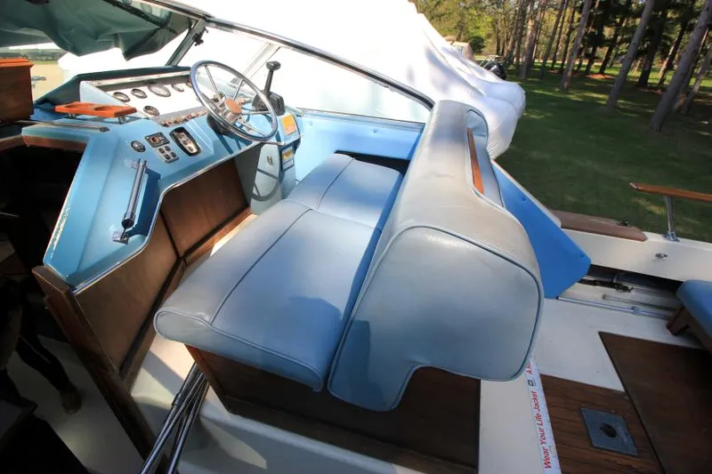 Slide: The Image of 1981 Sea Ray 245 SRV boat interior with blue seating and classic dashboard. - 10