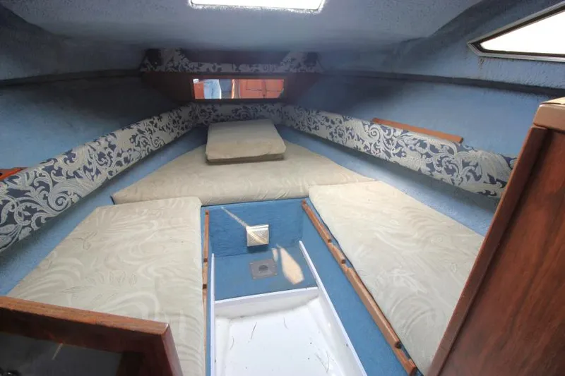 Slide: The Image of 1981 Sea Ray 245 SRV cabin interior with blue and white upholstery. - 14