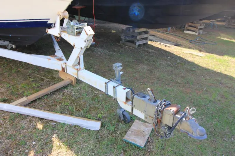 Slide: The Image of Trailer hitch of a 1981 Sea Ray 245 SRV boat on grass. - 4