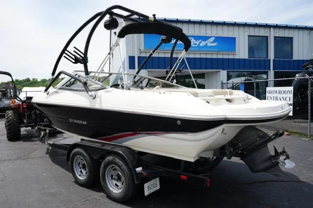 Slide: The Image of 2016 Stingray 208LR boat on trailer outside showroom. - 2