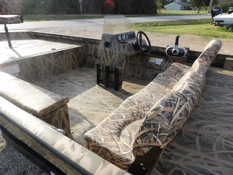 Slide: The Image of 2025 Crestliner 2070 Retriever SCHD boat with camouflage interior and steering console. - 10