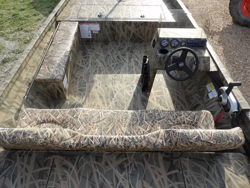 Slide: The Image of 2025 Crestliner 2070 Retriever SCHD boat interior with camouflage seating and steering console. - 14