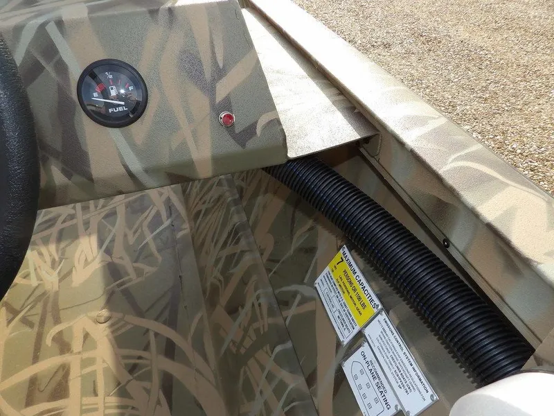 Slide: The Image of 2025 Crestliner 2070 Retriever SCHD interior with camouflage design and fuel gauge. - 17