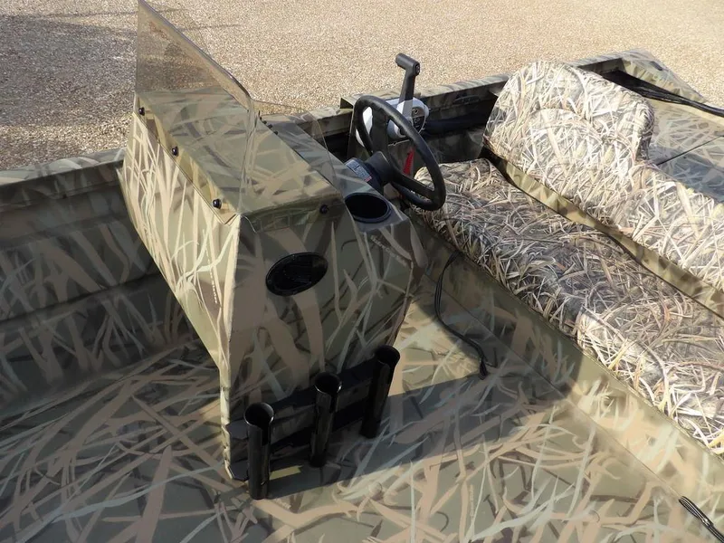 Slide: The Image of 2025 Crestliner 2070 Retriever SCHD boat interior with camouflage design and steering console. - 18