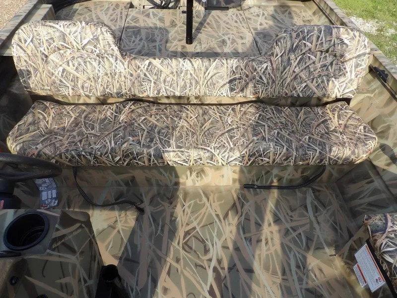 Slide: The Image of 2025 Crestliner 2070 Retriever SCHD boat with camouflage seating and interior design. - 19