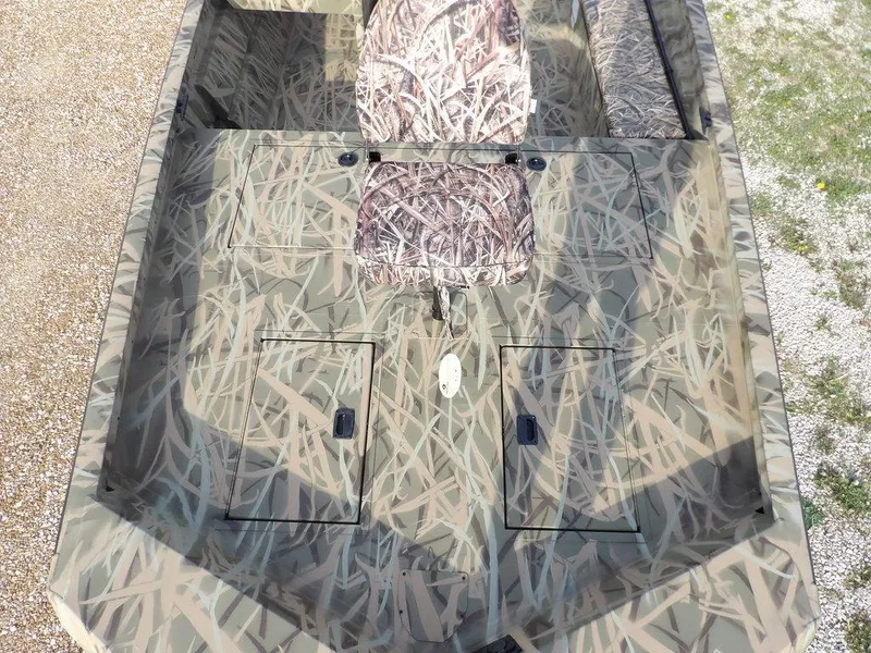 Slide: The Image of 2025 Crestliner 2070 Retriever SCHD boat with camouflage design and seating. - 24