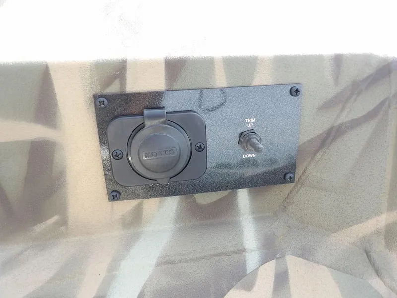 Slide: The Image of Control panel on 2025 Crestliner 2070 Retriever SCHD boat with trim switch and power outlet. - 26