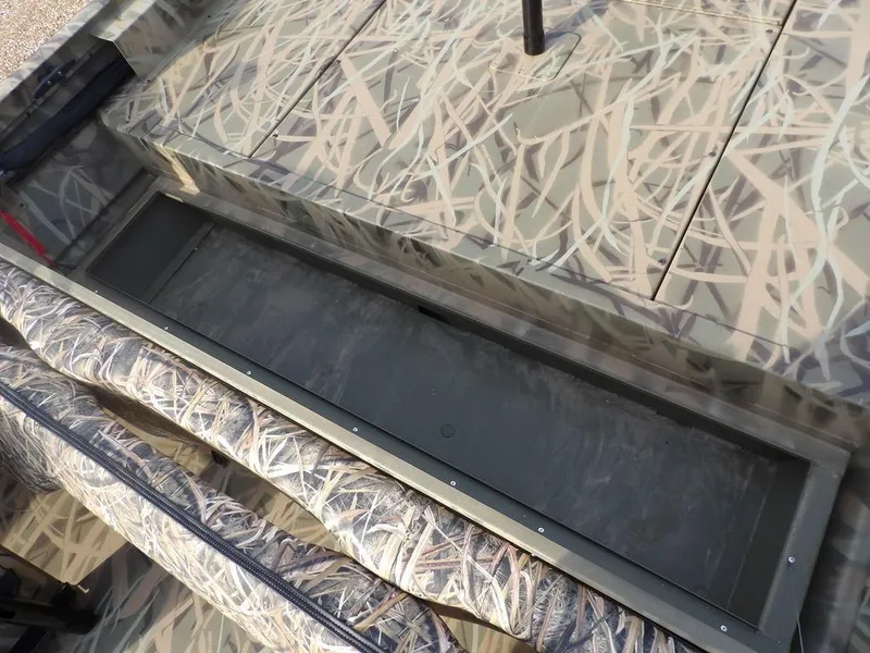Slide: The Image of 2025 Crestliner 2070 Retriever SCHD boat interior with camouflage design and storage compartment. - 27
