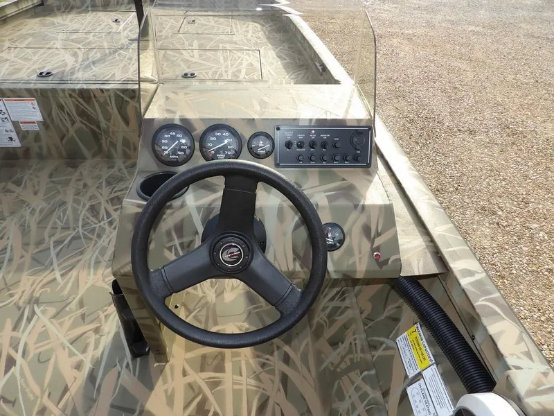 Slide: The Image of 2025 Crestliner 2070 Retriever SCHD boat dashboard with steering wheel and control panel. - 29