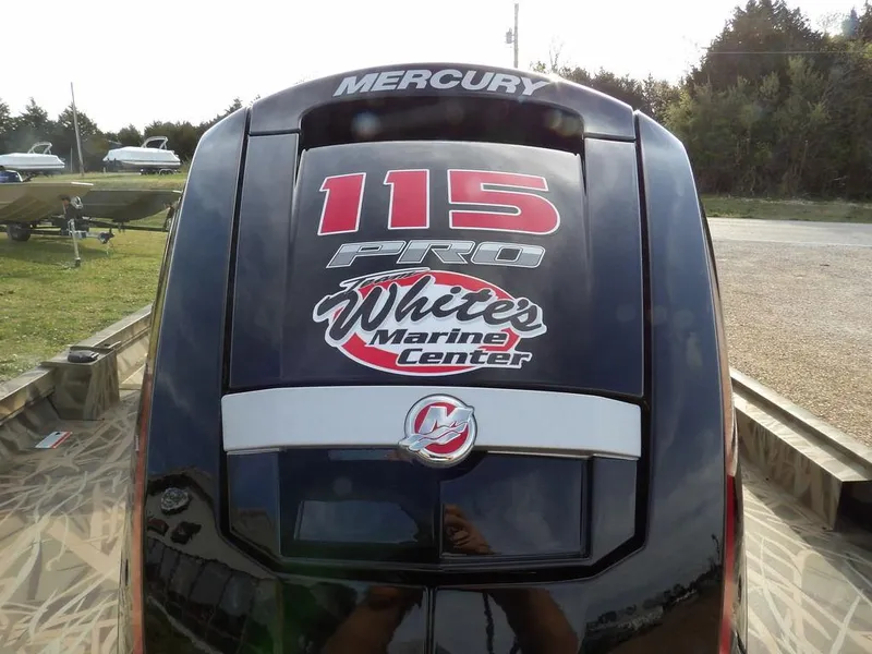Slide: The Image of Mercury 115 Pro outboard motor with White's Marine Center branding, rear view. - 31