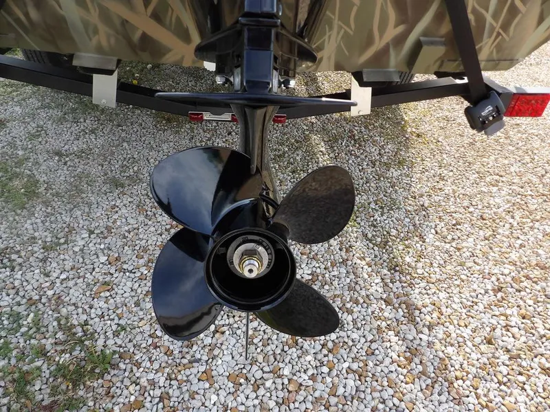 Slide: The Image of Propeller of 2025 Crestliner 2070 Retriever SCHD boat on gravel surface. - 32