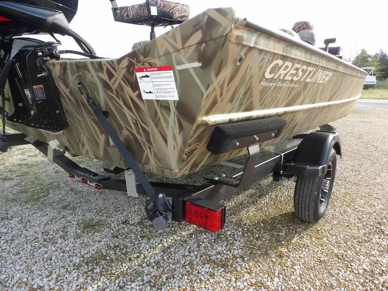 Slide: The Image of 2025 Crestliner 2070 Retriever SCHD boat with camouflage design on a trailer. - 36