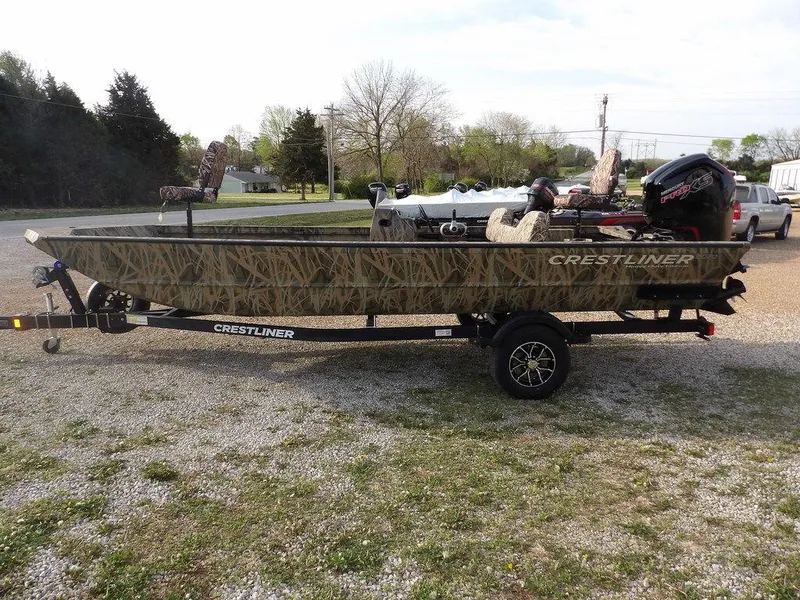 Slide: The Image of 2025 Crestliner 2070 Retriever SCHD boat on trailer, camo design, parked outdoors. - 5