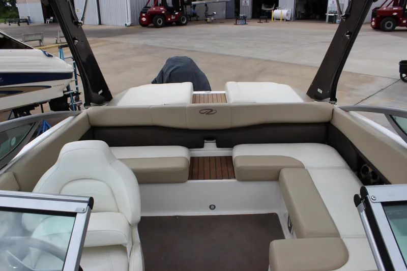 Slide: The Image of 2012 Regal 2100 RS Bowrider interior with beige seating and wood accents. - 16