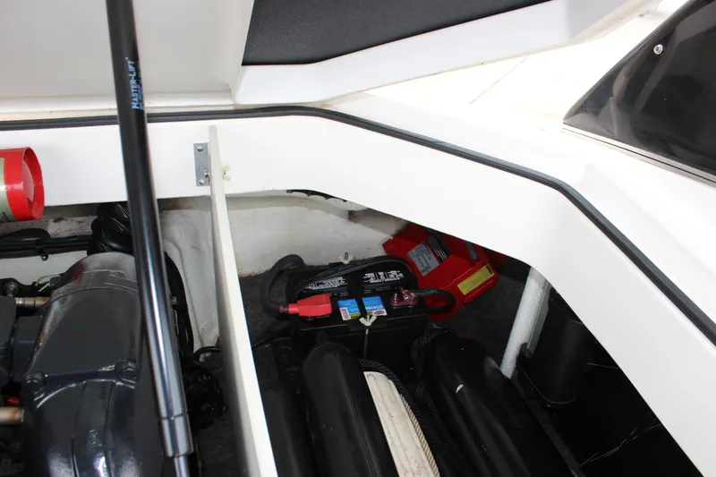 Slide: The Image of 2012 Regal 2100 RS Bowrider engine compartment with battery and components visible. - 18
