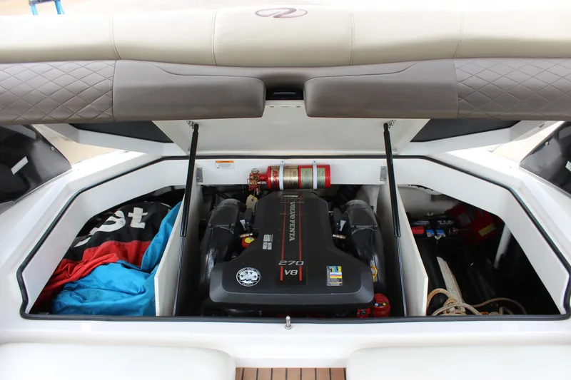 Slide: The Image of 2012 Regal 2100 RS Bowrider engine compartment with V8 engine and storage space. - 21