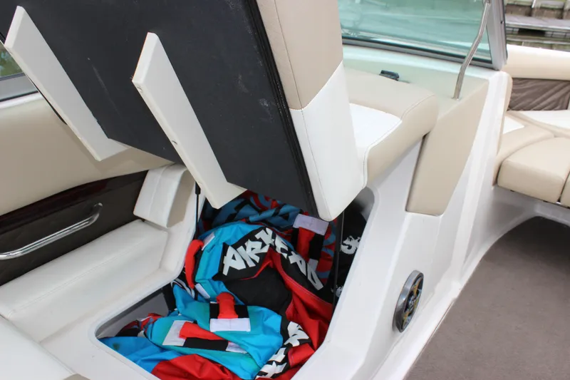 Slide: The Image of 2012 Regal 2100 RS Bowrider with open storage compartment and colorful life jackets. - 22
