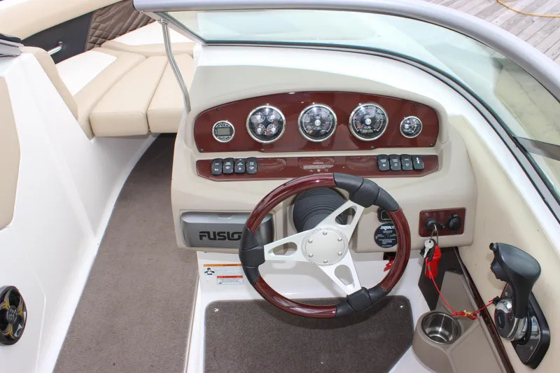 Slide: The Image of 2012 Regal 2100 RS Bowrider dashboard with steering wheel and control panel. - 24