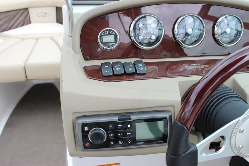 Slide: The Image of 2012 Regal 2100 RS Bowrider dashboard with gauges and controls. - 26