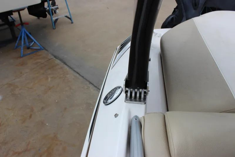 Slide: The Image of 2012 Regal 2100 RS Bowrider interior detail with beige seating and metal fixtures. - 28
