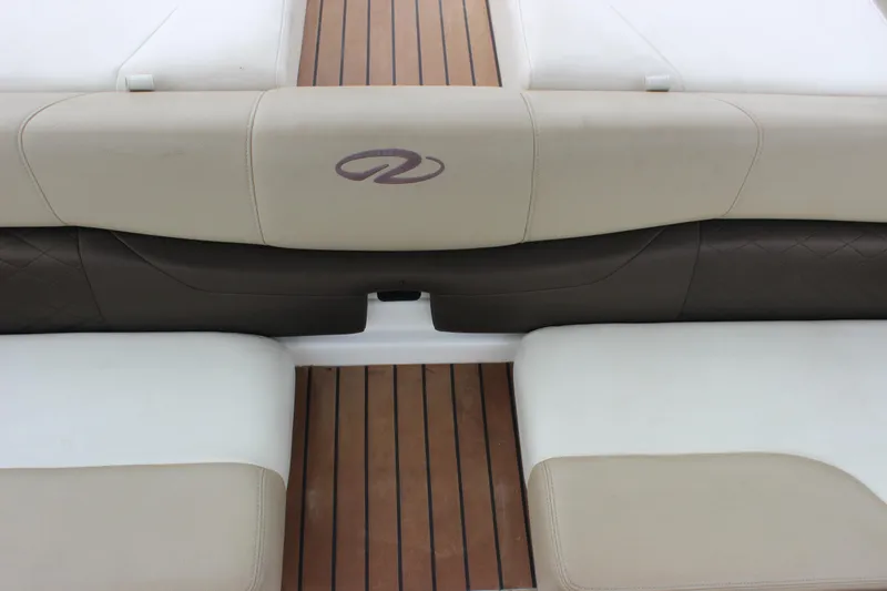 Slide: The Image of 2012 Regal 2100 RS Bowrider interior with beige and brown seating, wood flooring. - 31