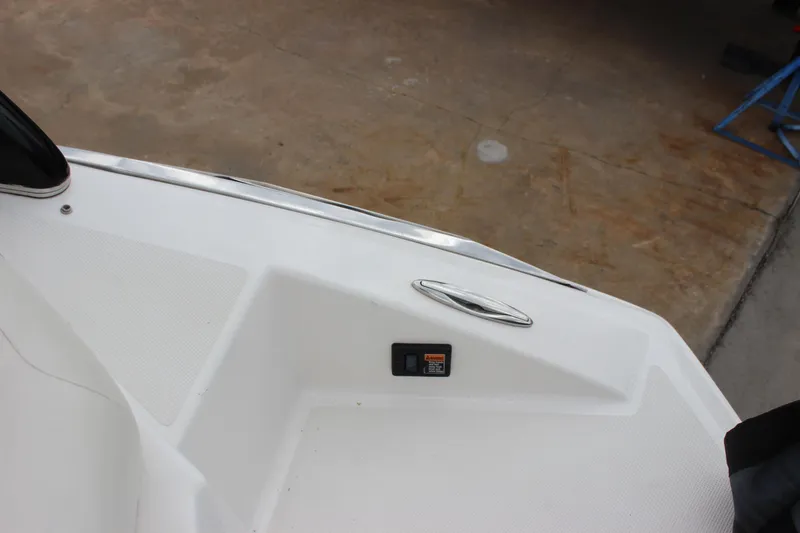 Slide: The Image of 2012 Regal 2100 RS Bowrider boat interior detail with handle and control panel. - 32