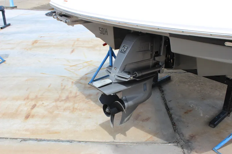 Slide: The Image of 2012 Regal 2100 RS Bowrider boat on stands, showing the outboard motor. - 6