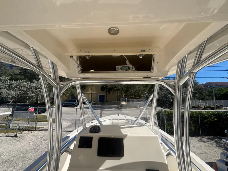 Slide: The Image of 2022 Cobia 237 Center Console boat interior with helm and overhead storage. - 10