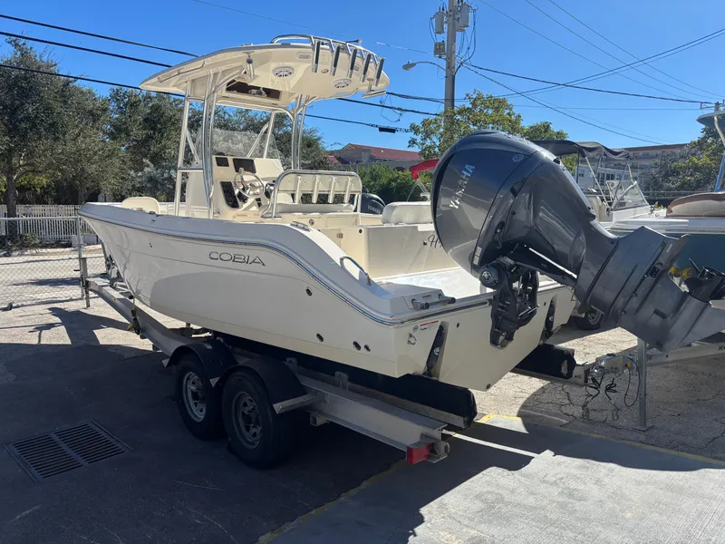 Slide: The Image of 2022 Cobia 237 Center Console boat on trailer, parked outdoors. - 3