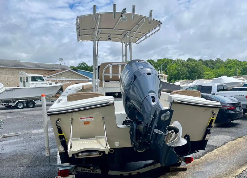 Slide: The Image of Parker 21 Special Edition boat, 2019 model, with outboard motor, parked outdoors. - 2