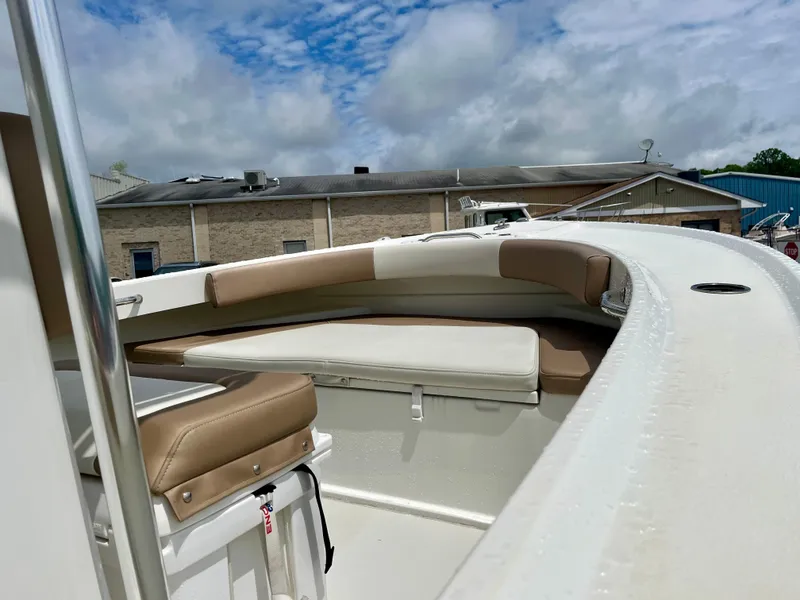 Slide: The Image of 2019 Parker 21 Special Edition boat with cushioned seating, under a partly cloudy sky. - 3