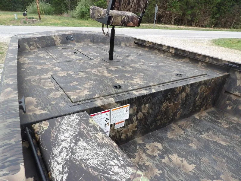 Slide: The Image of 2025 Crestliner 2070 Retriever SCHD boat with camouflage design, featuring a spacious deck. - 11